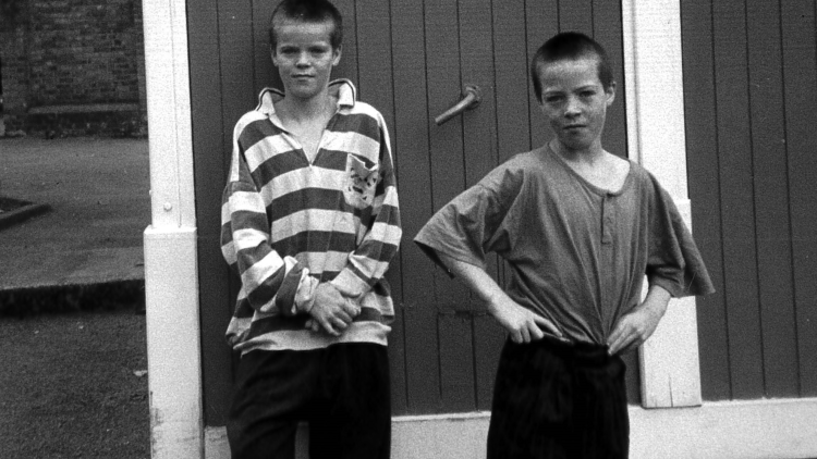 Two children outside the Irish Advice Centre at the Hammersmith and Fulham Irish Centre, year unknown.